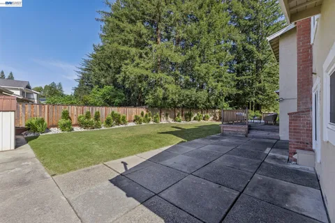 a view of a house with backyard porch and sitting area
