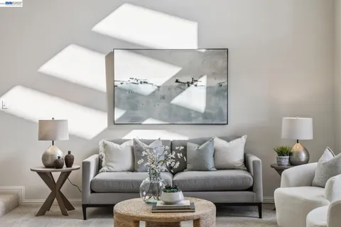 a living room with furniture and a large mirror