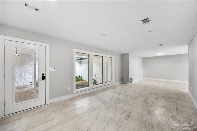 a view of an empty room with glass door