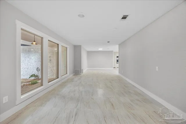 a view of an empty room with glass door