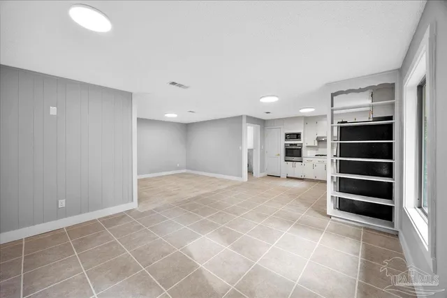 a view of wooden floor and windows in a room