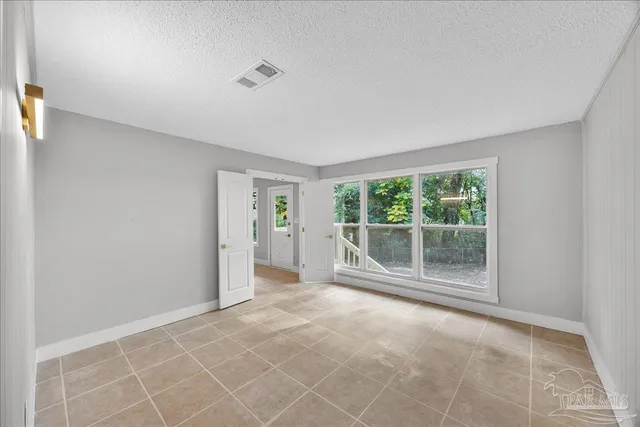 a view of empty room with floor to ceiling window