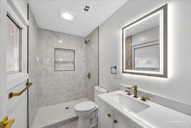 a bathroom with a sink toilet and shower