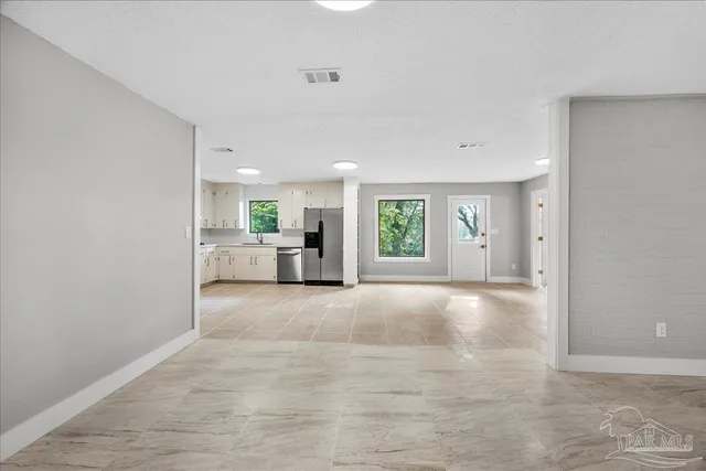 a view of a livingroom with a kitchen and a sink