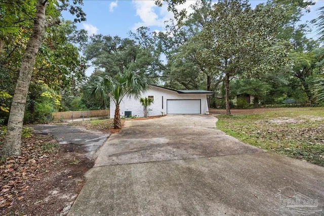 a view of a house with yard and a tree