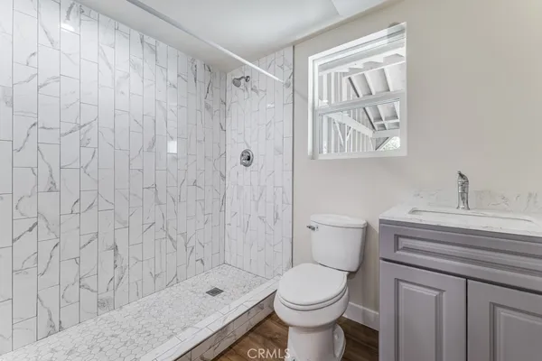 a bathroom with a sink a toilet and shower