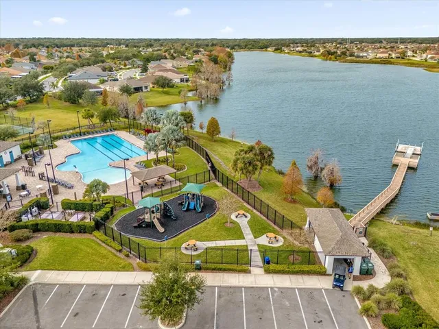 a view of swimming pool with outdoor seating and plants