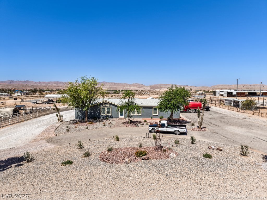 4375 Pinwheel Street Logandale, NV 89021 - Photo 43 of 52 An aerial view captures the home's broad lot, complete with ample parking and mountain views.