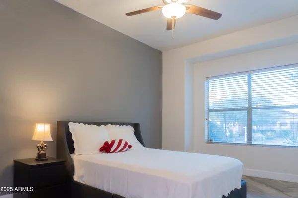a bedroom with a bed and a chandelier