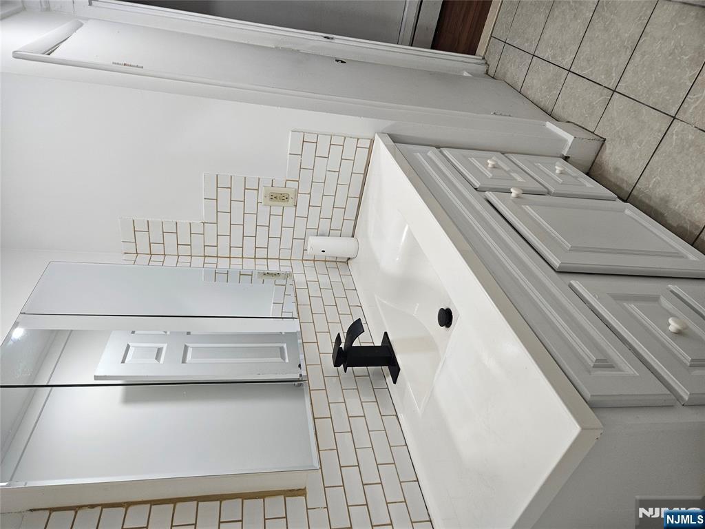 900 River Road, Unit 2A Edgewater, NJ 07020 - Photo 2 of 12 a bathroom with a sink and a mirror