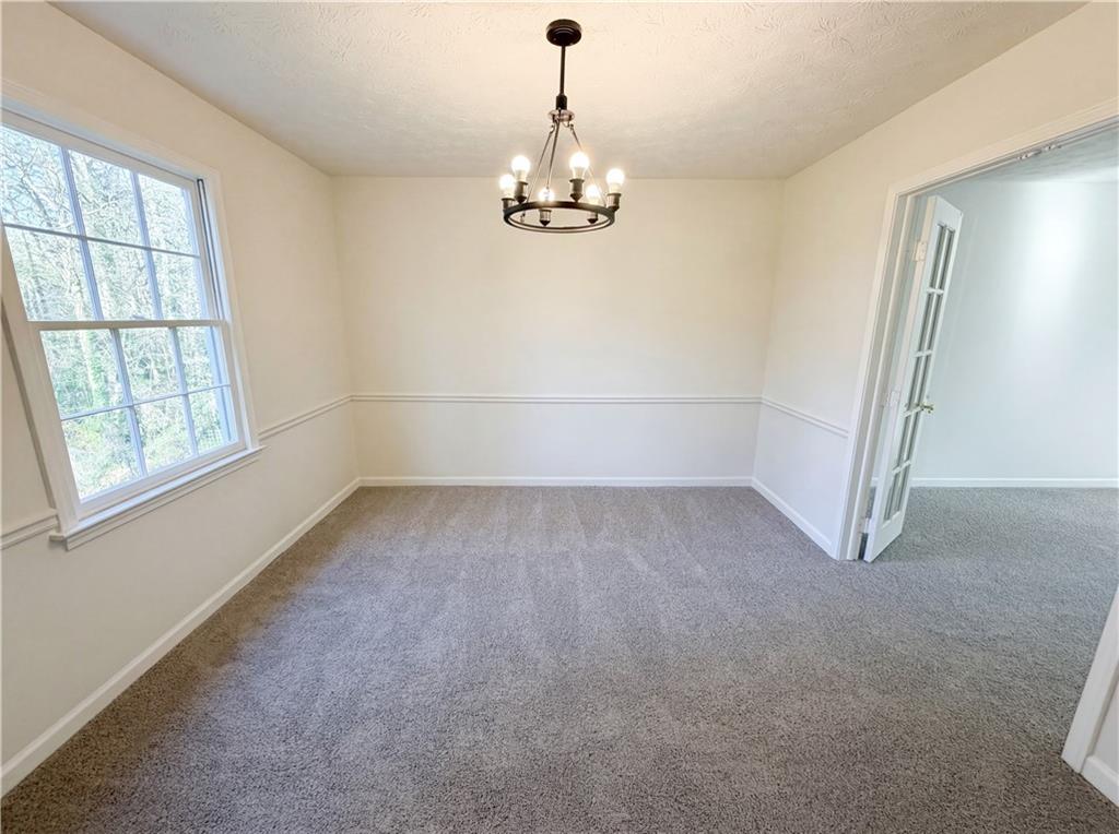 197 Rockbridge Road Southwest Lilburn, GA 30047 - Photo 11 of 27 wooden floor in an empty room with a window
