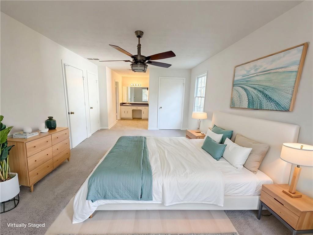 197 Rockbridge Road Southwest Lilburn, GA 30047 - Photo 12 of 27 a spacious bedroom with a bed and a chandelier