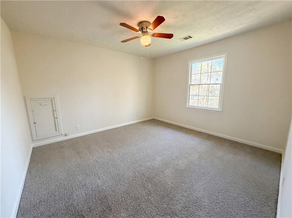 197 Rockbridge Road Southwest Lilburn, GA 30047 - Photo 15 of 27 a view of an empty room with a window