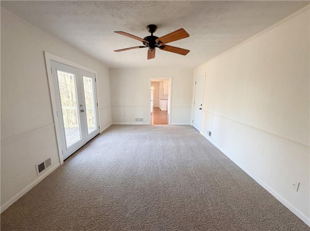 197 Rockbridge Road Southwest Lilburn, GA 30047 - Photo 17 of 27 a view of a livingroom with a ceiling fan and window