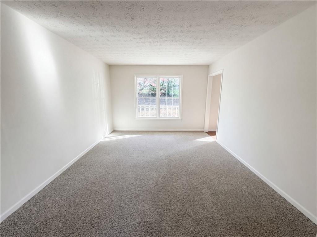 197 Rockbridge Road Southwest Lilburn, GA 30047 - Photo 18 of 27 an empty room with windows