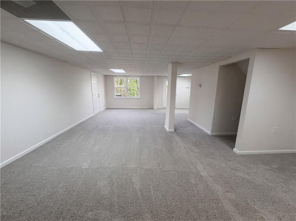 197 Rockbridge Road Southwest Lilburn, GA 30047 - Photo 20 of 27 a view of a big room with windows and cabinet