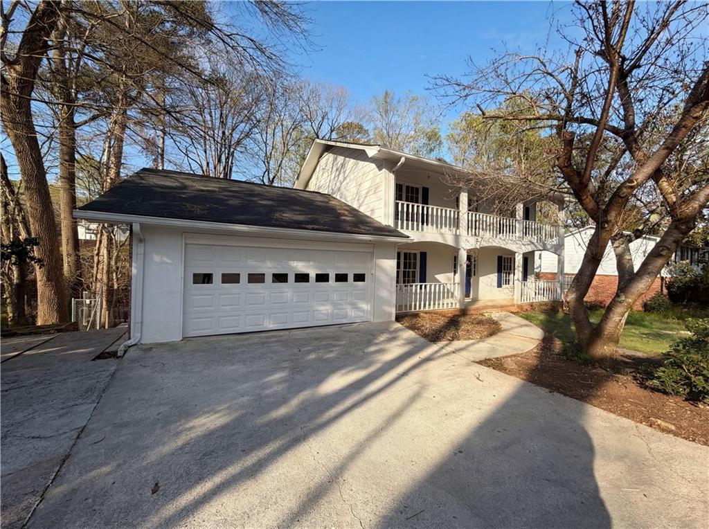 197 Rockbridge Road Southwest Lilburn, GA 30047 - Photo 2 of 27 a front view of a house with a yard