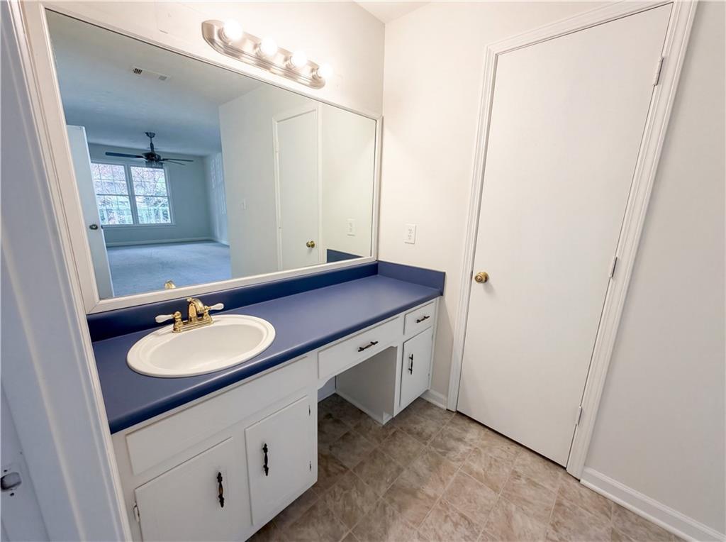 197 Rockbridge Road Southwest Lilburn, GA 30047 - Photo 23 of 27 a bathroom with a sink and a mirror