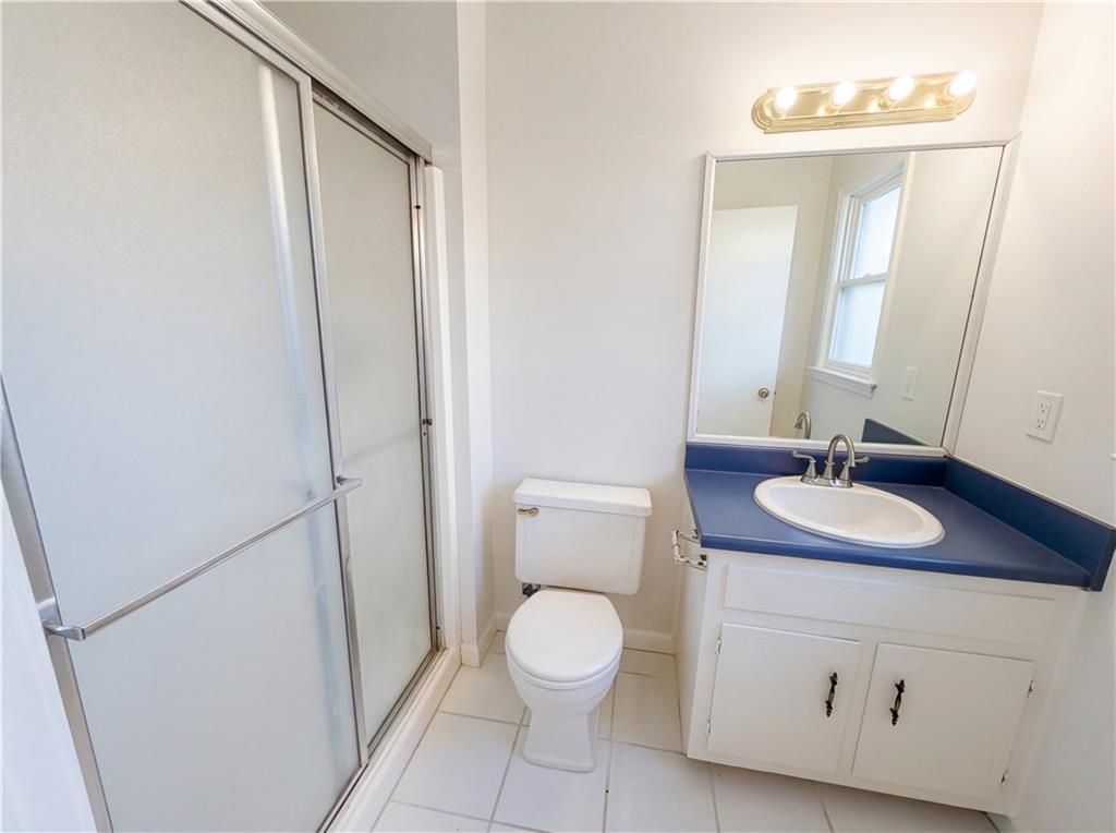 197 Rockbridge Road Southwest Lilburn, GA 30047 - Photo 24 of 27 a bathroom with a toilet sink and mirror