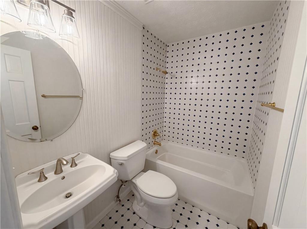 197 Rockbridge Road Southwest Lilburn, GA 30047 - Photo 26 of 27 a bathroom with a sink toilet and shower