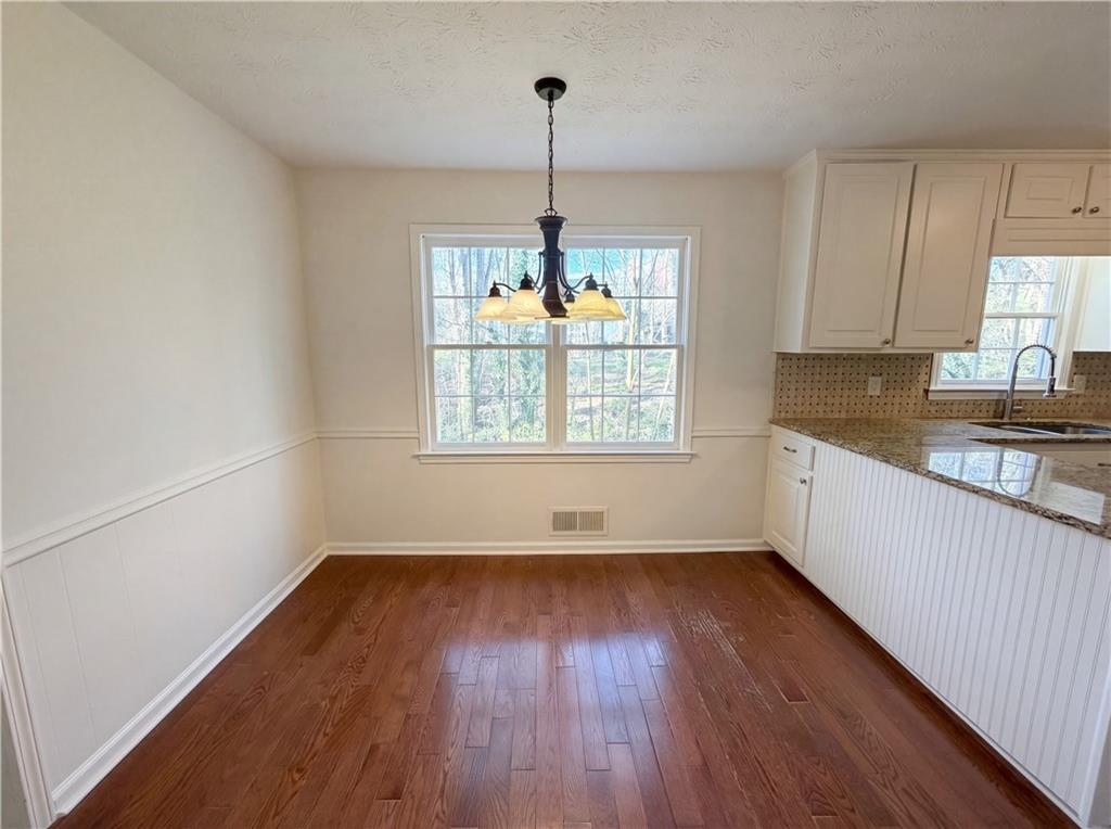 197 Rockbridge Road Southwest Lilburn, GA 30047 - Photo 6 of 27 a view of a kitchen with wooden floor and a window
