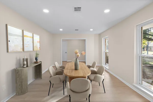 a dining room with furniture and a window