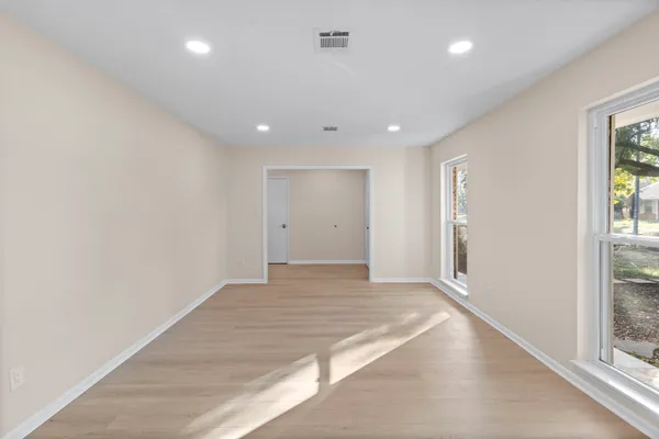 an empty room with windows and entrance