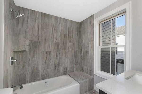 9 Cedar Street, Unit 1 Boston, MA 02119 - Photo 15 of 16 a bathroom with a tub and shower