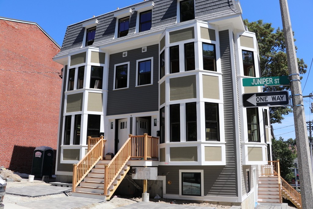 9 Cedar Street, Unit 1 Boston, MA 02119 - Photo 2 of 16 a view of a large building with a door