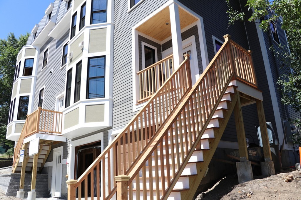 9 Cedar Street, Unit 1 Boston, MA 02119 - Photo 4 of 16 a view of an buildings with wooden stairs