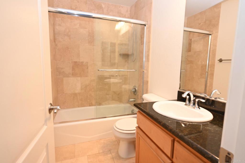 4035 Bluff View Way Carlsbad, CA 92008 - Photo 19 of 38 a bathroom with a granite countertop sink toilet and shower