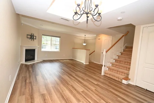 wooden floor in an empty room with a fireplace