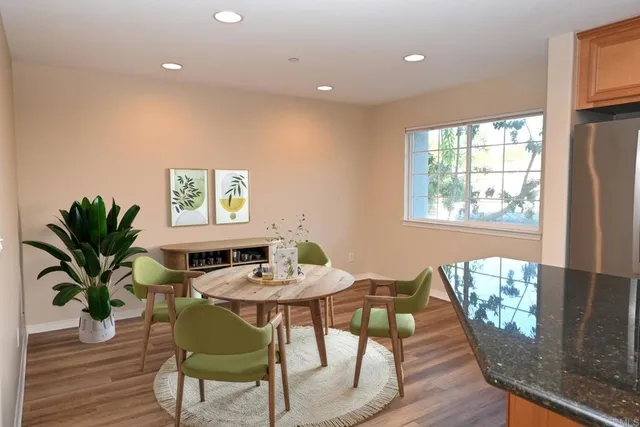 a view of a dining room with furniture window and wooden floor