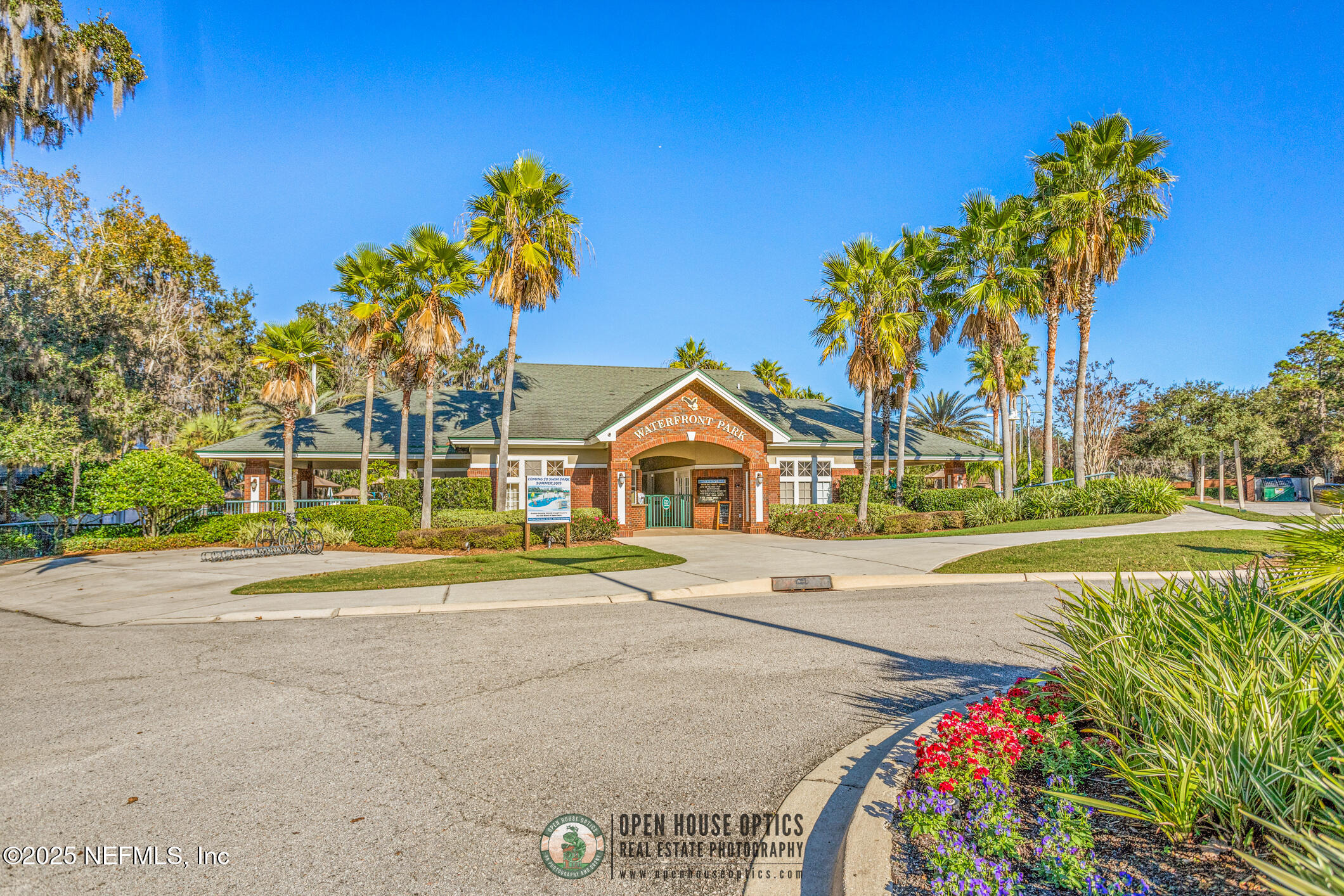 2676 Country Side Drive Fleming Island, FL 32003 - Photo 115 of 125 a front view of a house with a big yard and potted plants