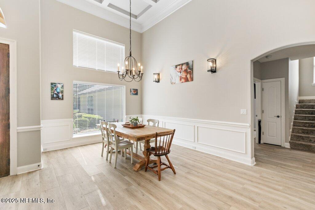 2676 Country Side Drive Fleming Island, FL 32003 - Photo 12 of 125 a dining room with furniture a chandelier and wooden floor