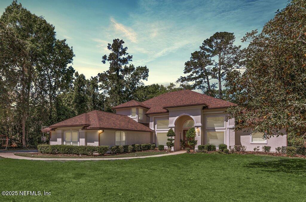 2676 Country Side Drive Fleming Island, FL 32003 - Photo 2 of 125 a front view of a house with a garden