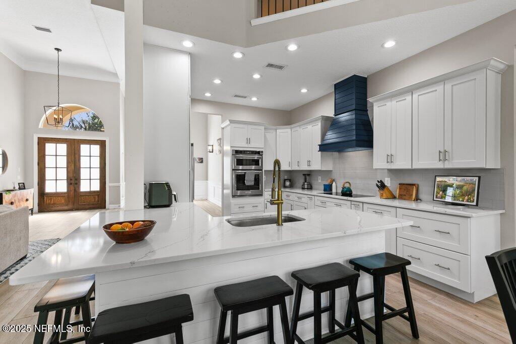2676 Country Side Drive Fleming Island, FL 32003 - Photo 24 of 125 a kitchen with stainless steel appliances granite countertop a table chairs and a refrigerator