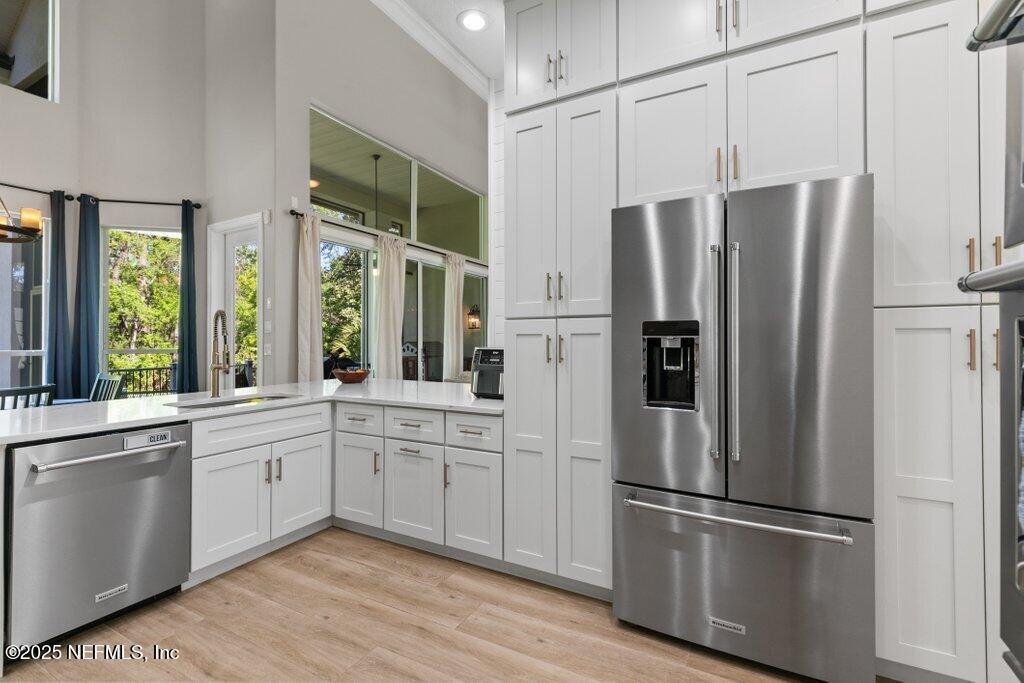 2676 Country Side Drive Fleming Island, FL 32003 - Photo 30 of 125 a kitchen with stainless steel appliances a refrigerator sink and cabinets