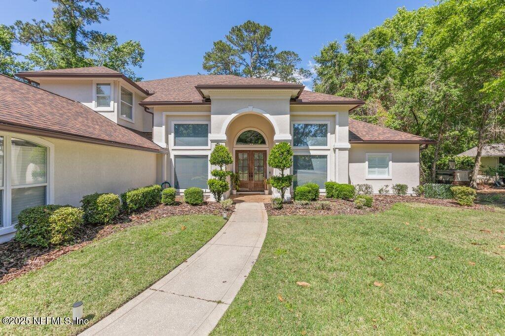 2676 Country Side Drive Fleming Island, FL 32003 - Photo 3 of 125 a front view of a house with a garden