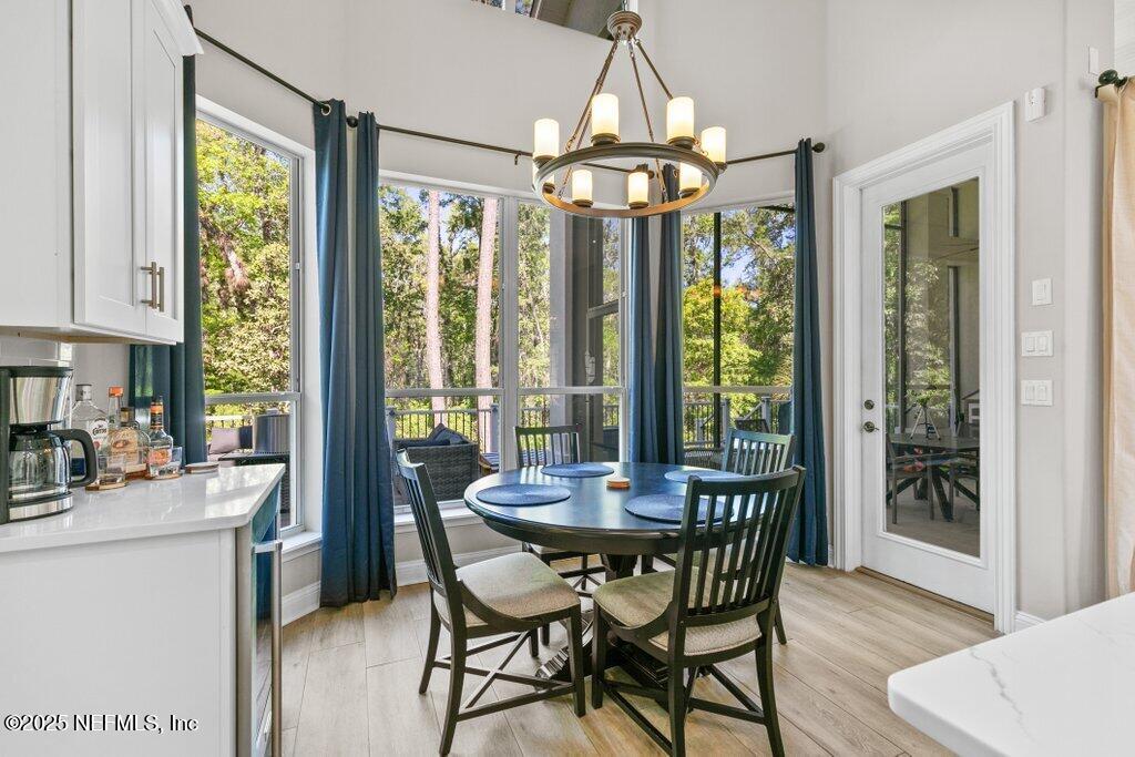2676 Country Side Drive Fleming Island, FL 32003 - Photo 32 of 125 a dining room with furniture a chandelier and wooden floor