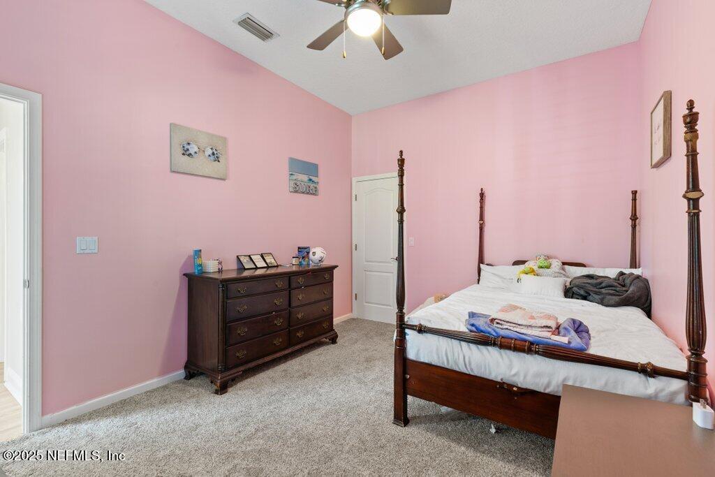 2676 Country Side Drive Fleming Island, FL 32003 - Photo 36 of 125 a bed room with a bed and a chandelier