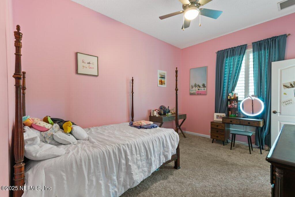 2676 Country Side Drive Fleming Island, FL 32003 - Photo 37 of 125 a bedroom with a bed and a chandelier