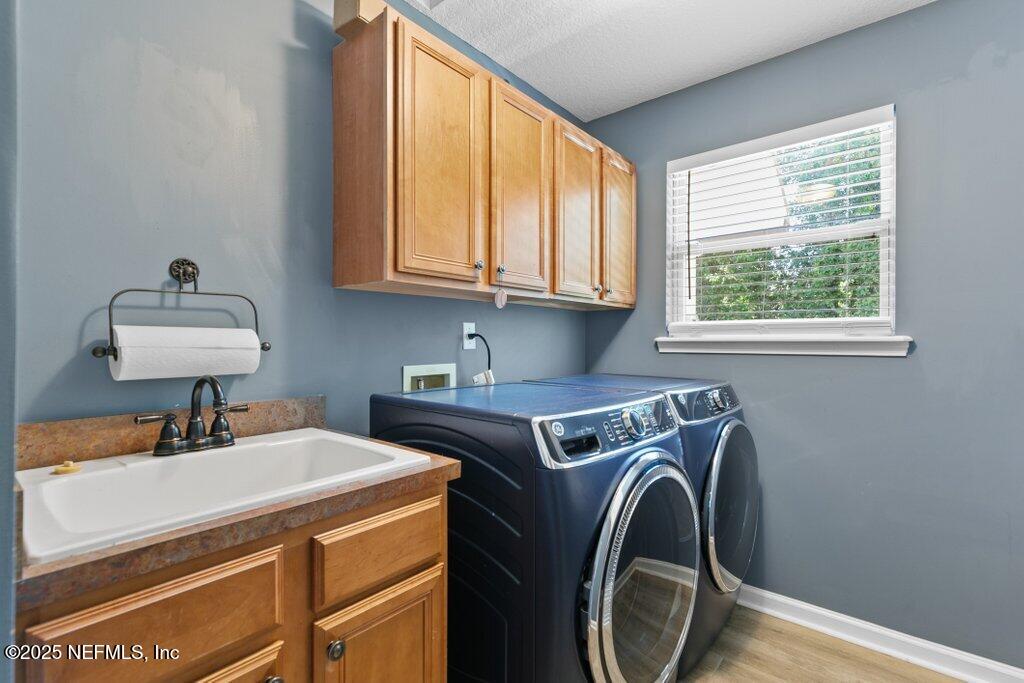 2676 Country Side Drive Fleming Island, FL 32003 - Photo 55 of 125 a utility room with dryer and washer