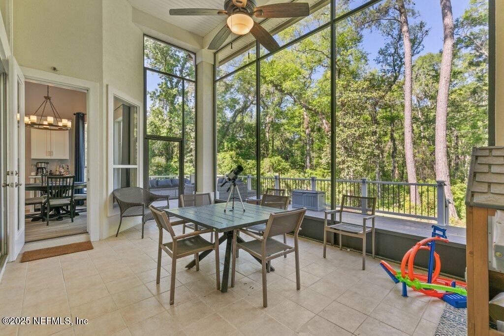 2676 Country Side Drive Fleming Island, FL 32003 - Photo 58 of 125 a dining room with furniture and a floor to ceiling window