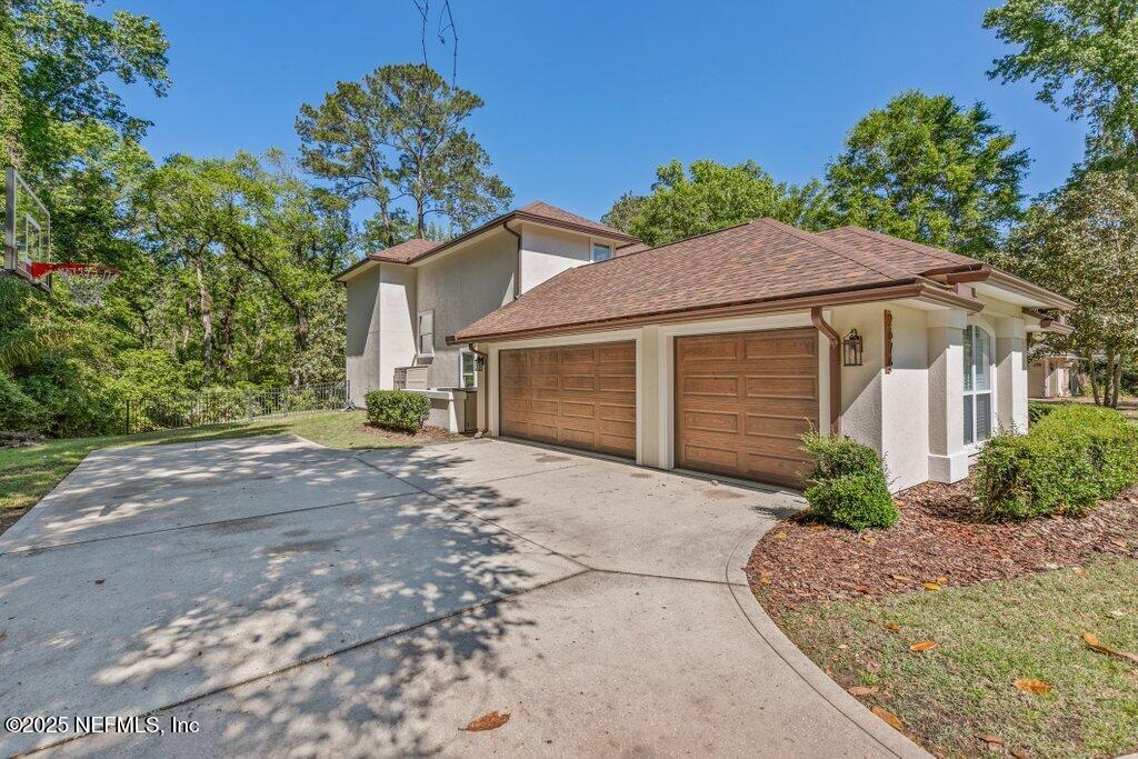 2676 Country Side Drive Fleming Island, FL 32003 - Photo 78 of 125 a front view of a house with a garden