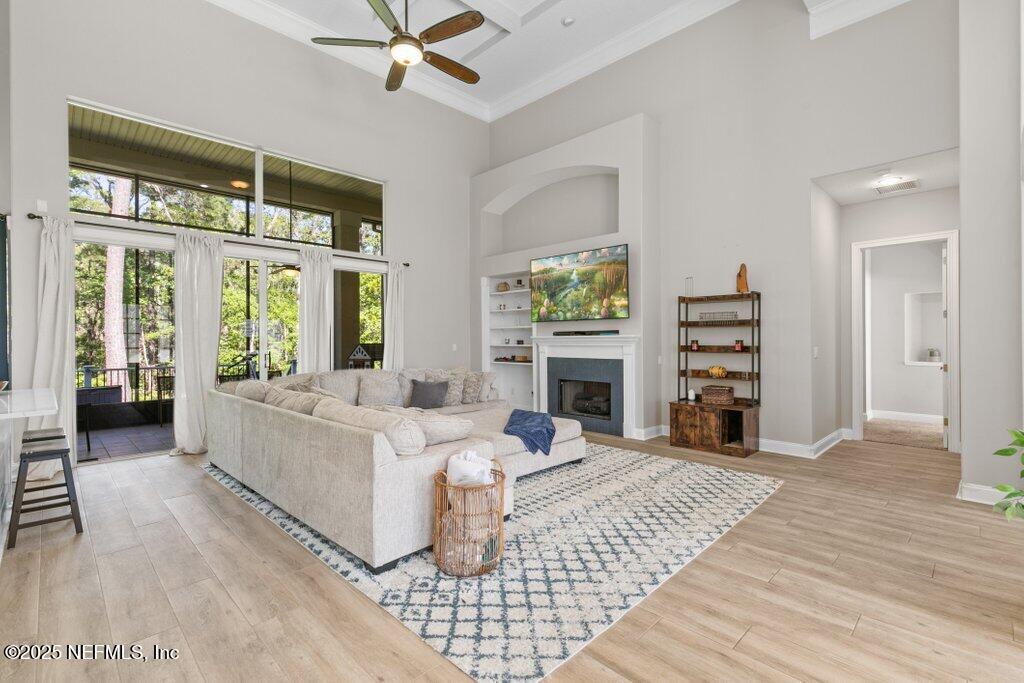 2676 Country Side Drive Fleming Island, FL 32003 - Photo 9 of 125 a living room with furniture fireplace and a large window