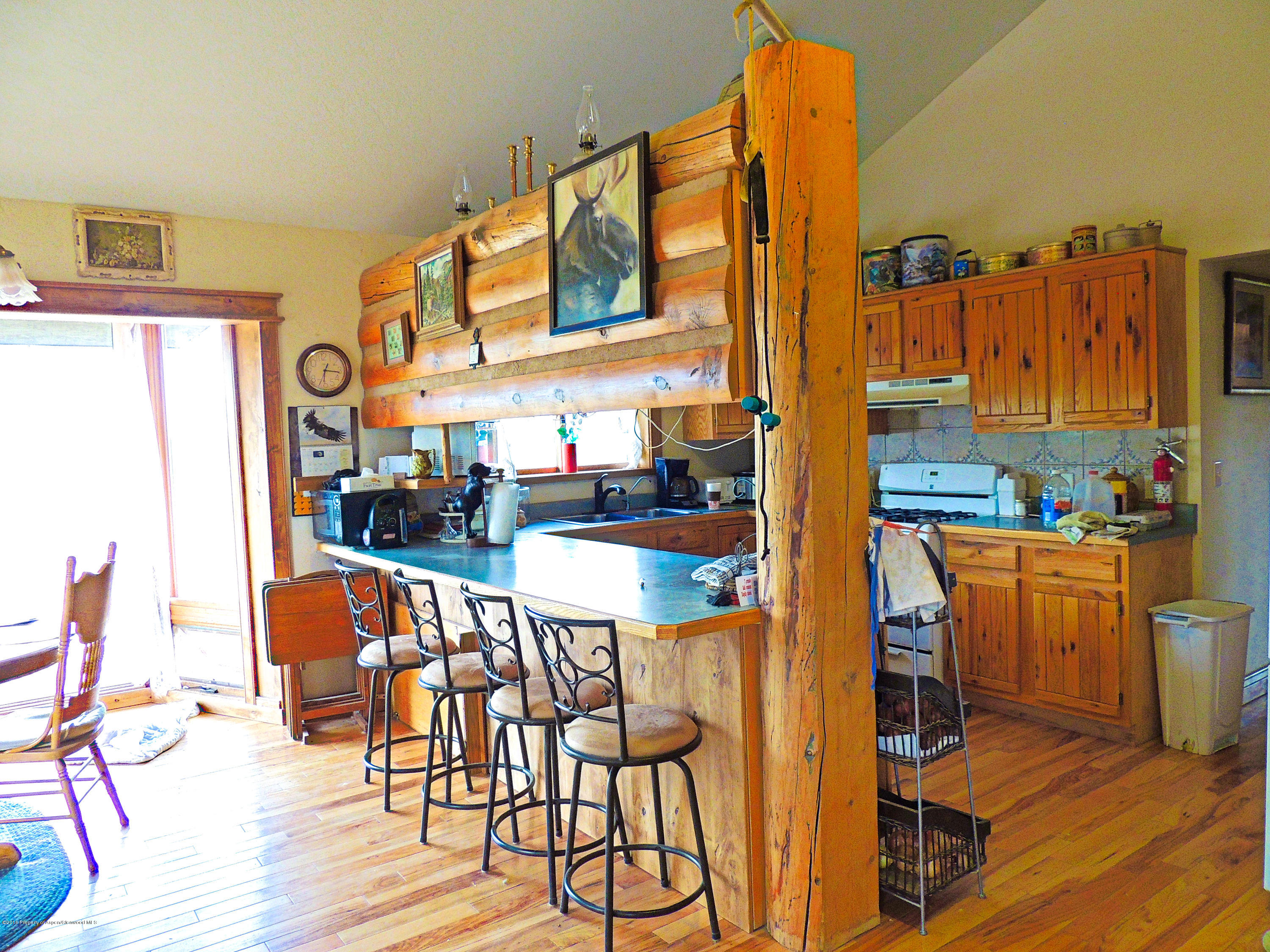 277 Miller Lane Rifle, CO 81650 - Photo 12 of 22 a view of a dining room with furniture one side kitchen view and wooden floor