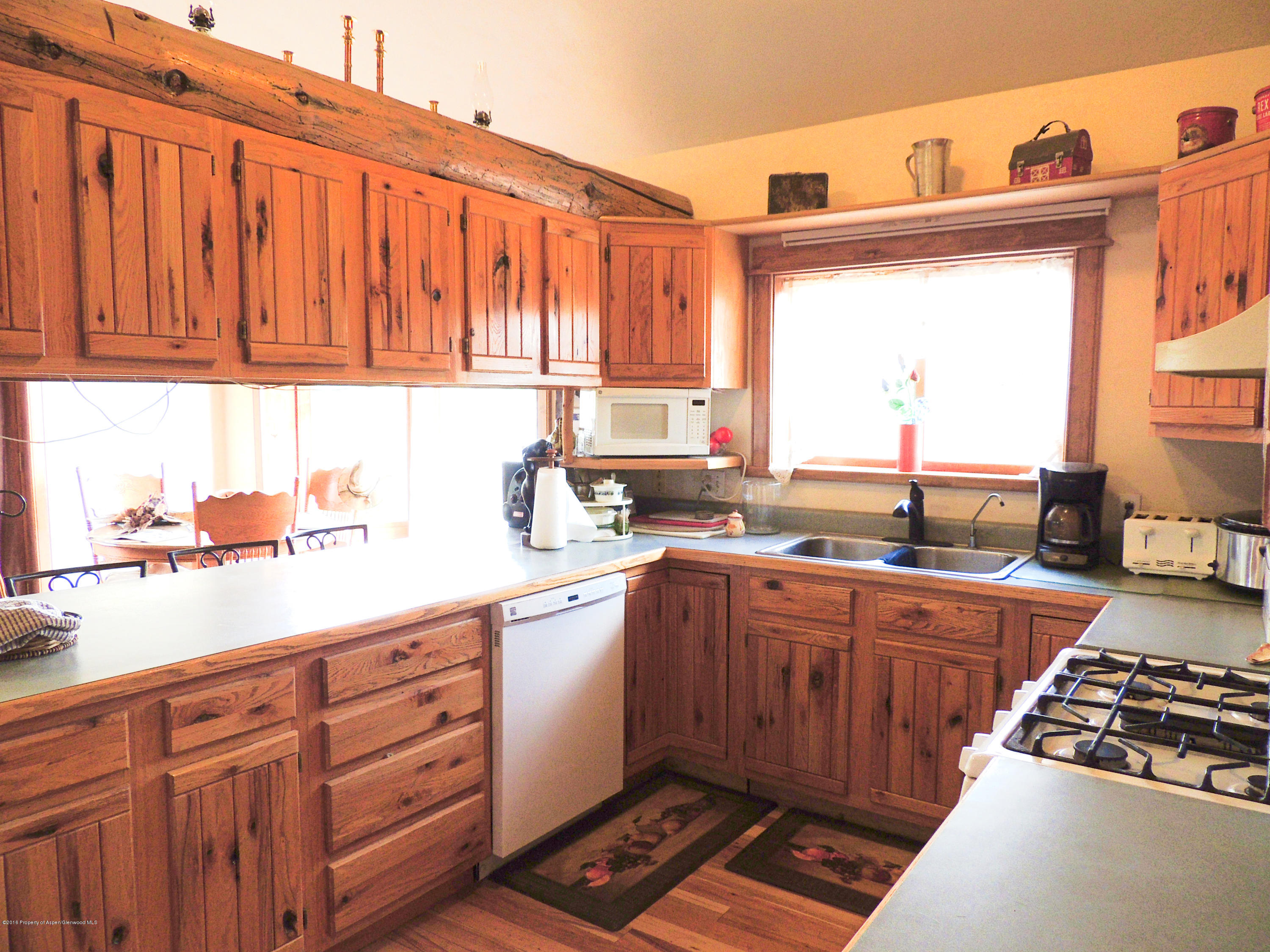 277 Miller Lane Rifle, CO 81650 - Photo 13 of 22 a kitchen with stainless steel appliances granite countertop a sink stove and cabinets