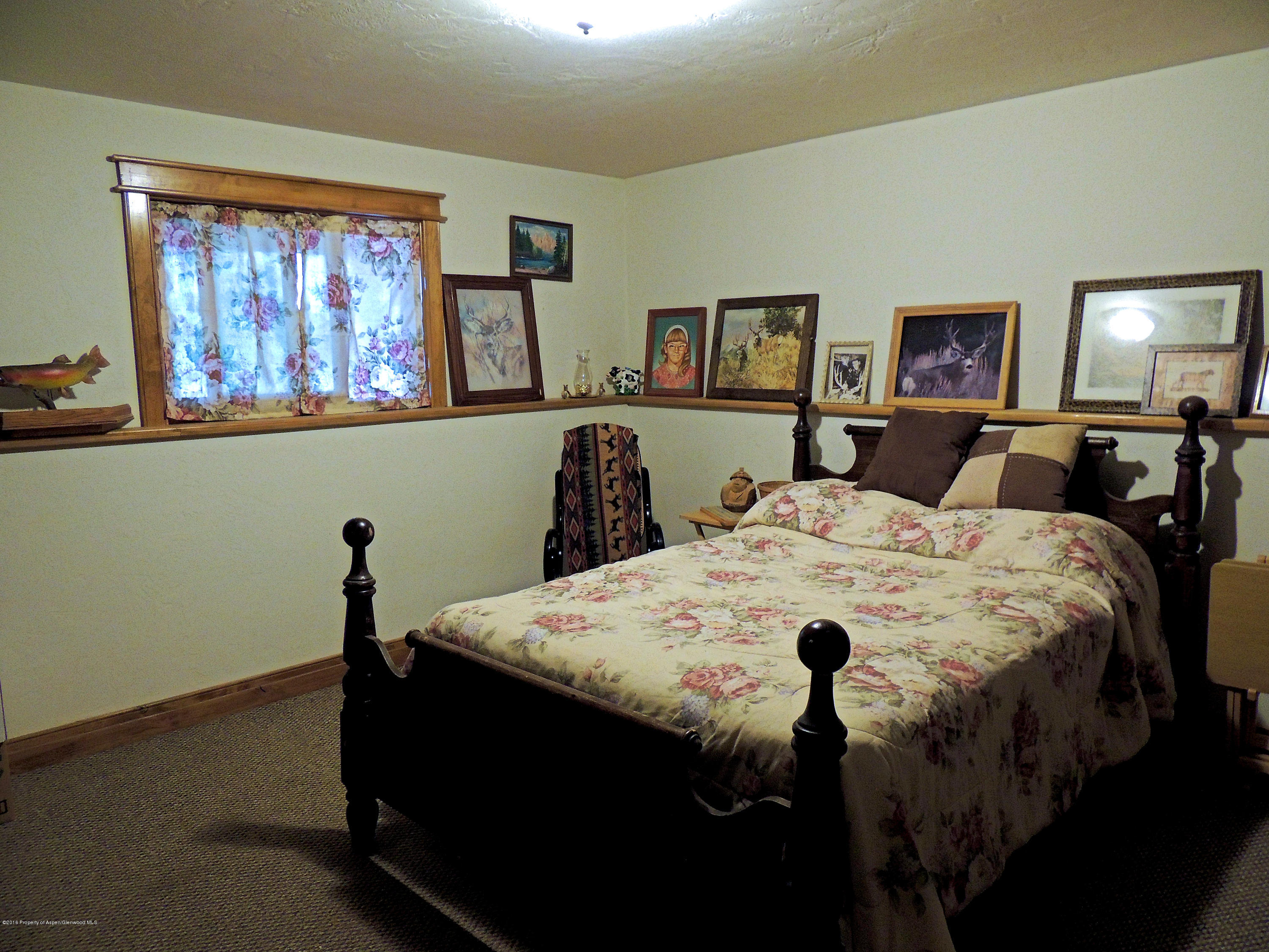 277 Miller Lane Rifle, CO 81650 - Photo 20 of 22 a large bed sitting in a bedroom and a table