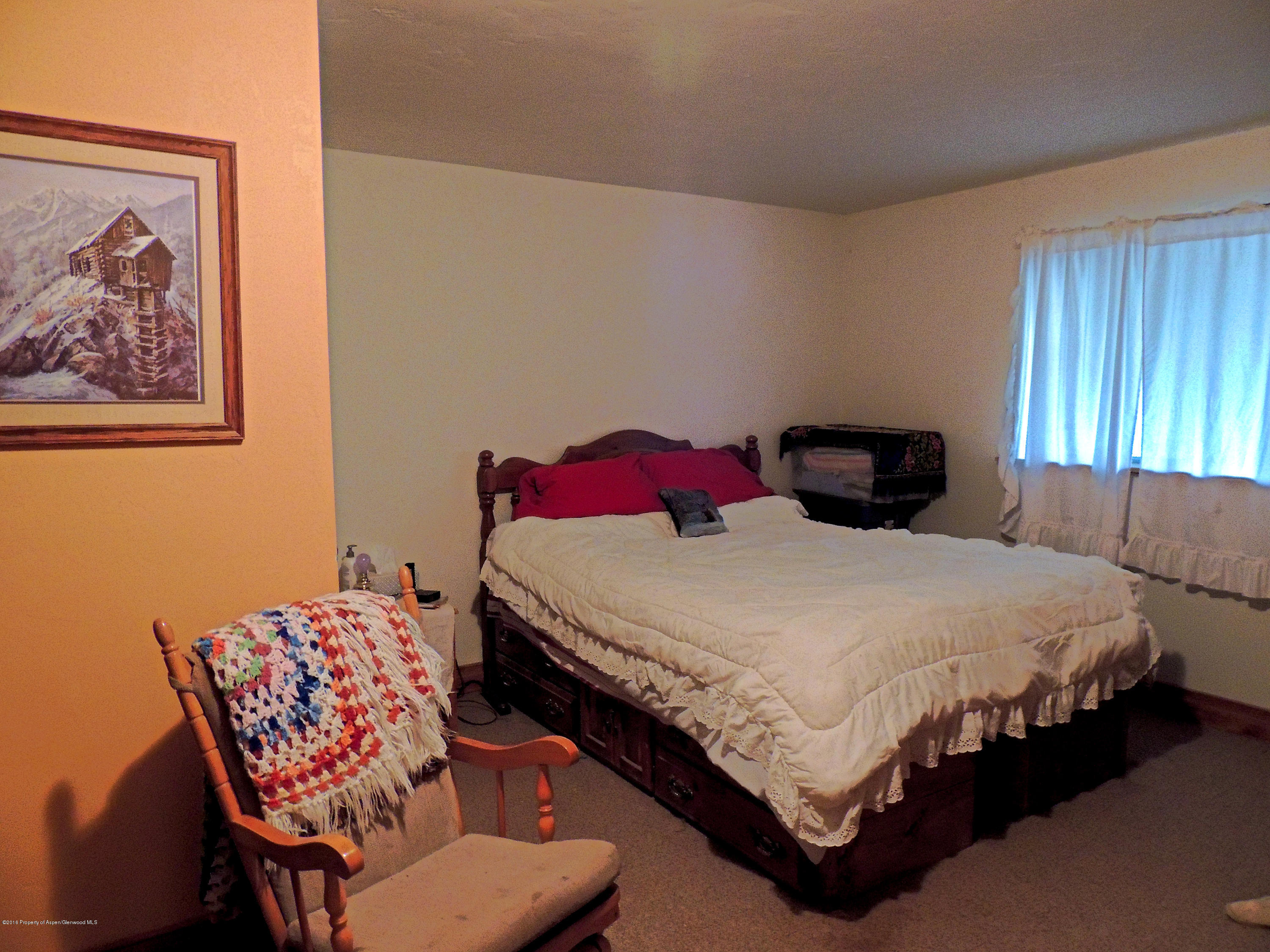 277 Miller Lane Rifle, CO 81650 - Photo 21 of 22 a bedroom with a bed and dresser